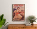 Reklamaffisch vintage Paris–Niort, sommarnyheter, inramad ovanför en träbyrå, mellan växter.