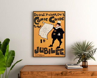 Vintageaffisch Dudley Hardy, comic guide, inramad ovanför en träbyrå mellan växter.