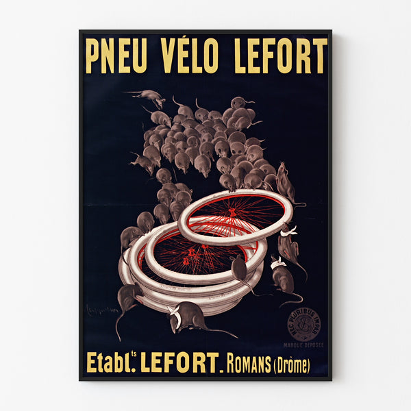 Vintage affisch Pneus vélo Lefort, upphängd i tunn ram på ljus vägg.
